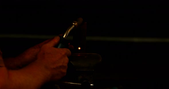 Blacksmith using a welding torch