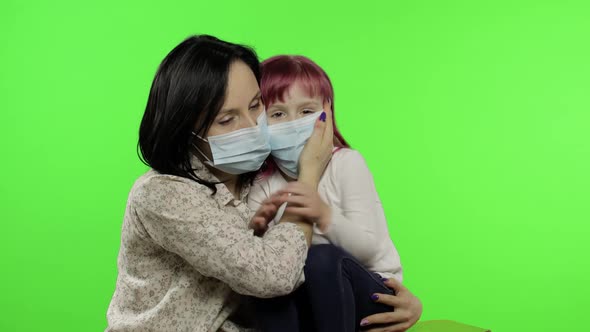 Sick Mother Hug Daughter in Medical Mask. Coronavirus Concept. Family Quarantine