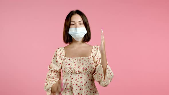 Woman in Protective Mask Applies Disinfectant Antiseptic To Her Hands and Then Shows - It Is Clean