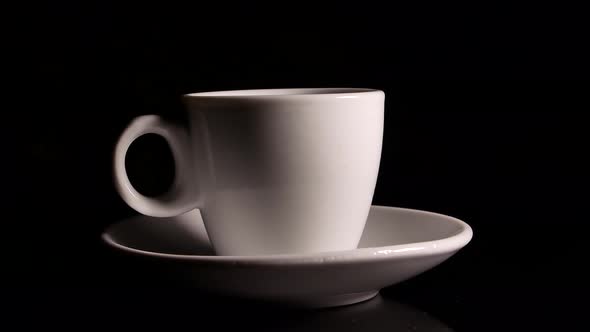 Ceramic coffee cup rotates on a black background