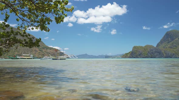 El Nido Bay. Palawan, Philippines. Low Angle View of Bangka Boats Floating in Shallow Bay By Noon