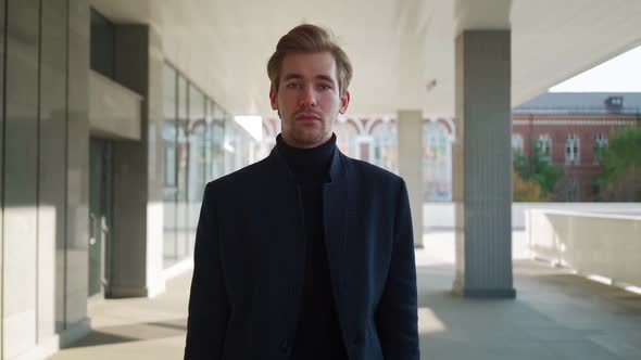 Portrait. Serious Handsome Young Business Man Walking in the Downtown.