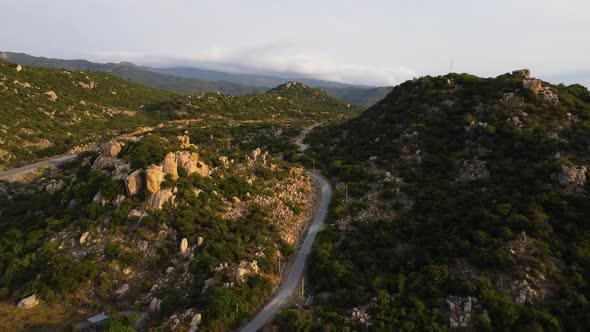 Aerial flying over road in Nui chua National Park during golden hour, Vietnam