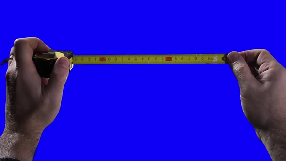 Male Hand holding a Measuring Tape over Blue Screen.