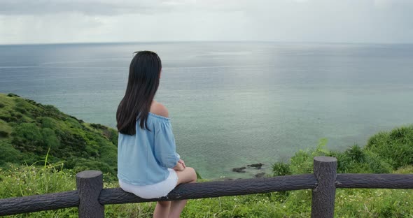 Woman enjoy the sea view at ishigaki island