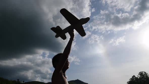 Poor Boy Holding Toy Airplane 