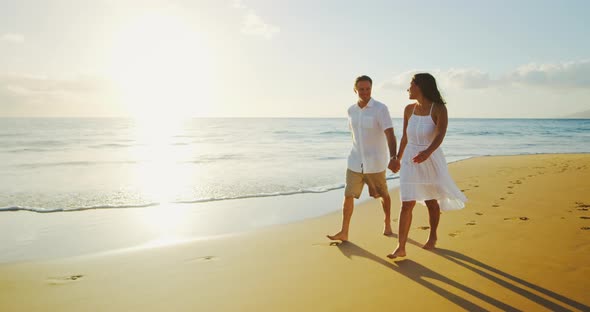 Couple Walking on the Beach at Sunset