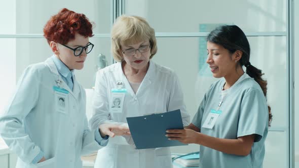 Multiethnic Female Doctors Having Discussion in Medical Office