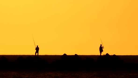 Human Silhouettes At Sunset
