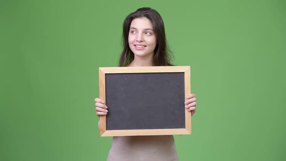 Young Happy Beautiful Woman Thinking While Holding Blackboard