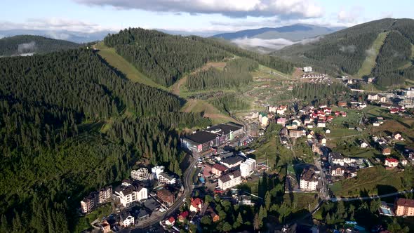 Aerial View of Sunrise Above Mountains Village