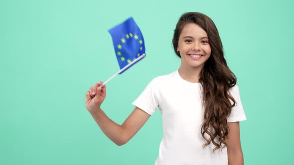 Portrait of Happy Teen Girl Waving European Union Flag on Blue Background Travel