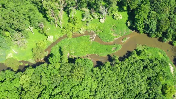 Aerial view of a river flowing through a beautiful landscape 