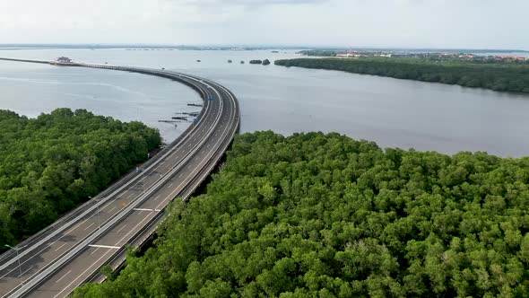 South of Mandara Toll Road and Gerbang Tol in Bali Indonesia above the Gulf of Benoa, Aerial dolly l