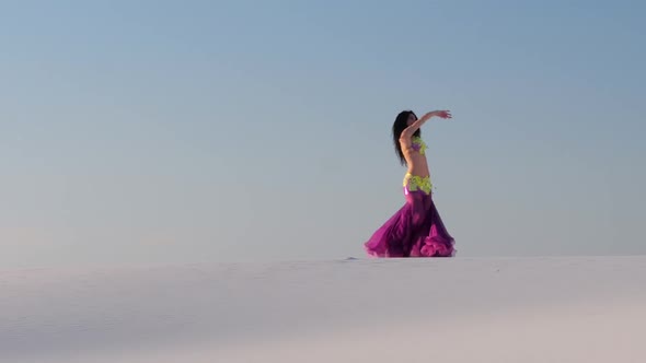 Girl Dances Belly Dancing in the Sandy Desert, Her Movements Are Unique