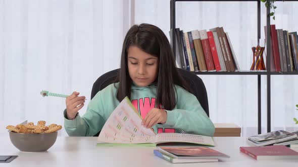 Little girl doing homework at home.
