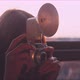 Woman photographer taking a picture on the balcony during golden hour - VideoHive Item for Sale