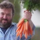 Happy farmer or seller with bunch of fresh carrots - VideoHive Item for Sale