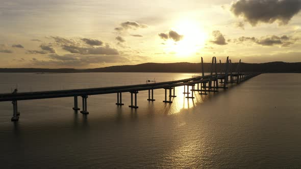 An aerial shot of the Mario M. Cuomo Bridge taken on the north side. The camera dolly out from the b