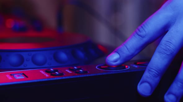 Closeup Digital Mixing Console and Hands Adjusting Fader