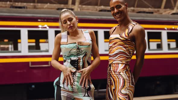 Fashion Models Posing To Camera In Train Station