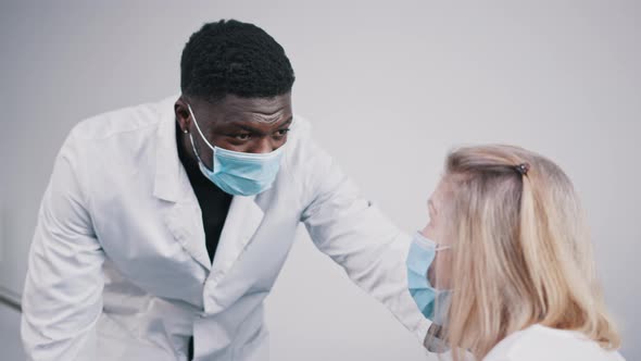 African American Doctor and Elderly Caucasian Woman Patient