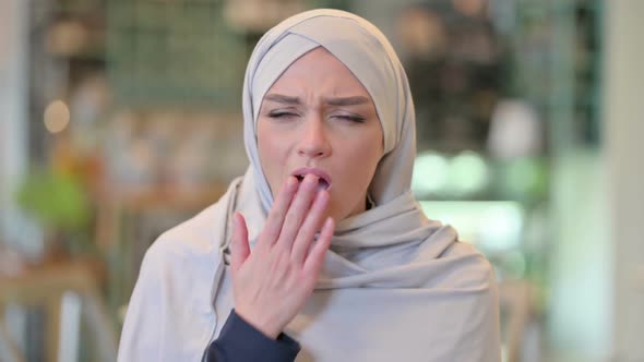 Portrait of Exhausted Young Arab Woman Yawning