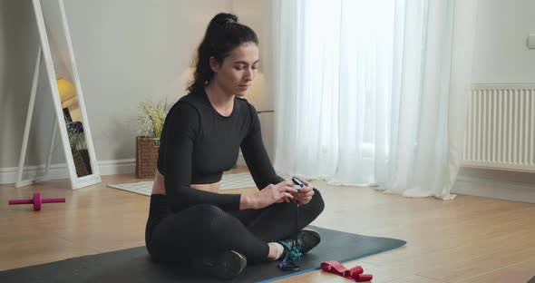 Caucasian Brunette Woman Measuring Oxygen Saturation Level with Pulse Oximeter. Portrait of Fit