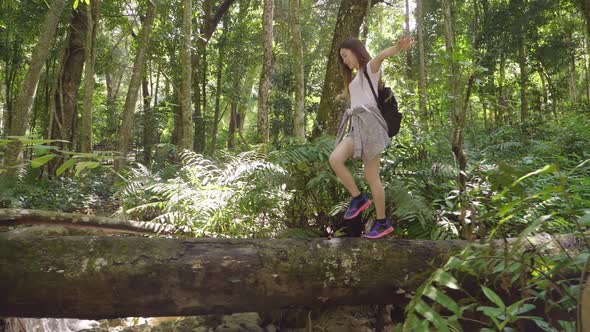 Girl Walking On Timber In Forest