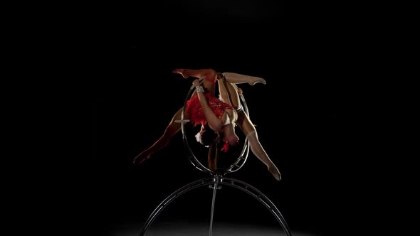 Representation of Two Acrobats in the Air on Stage. Black Background