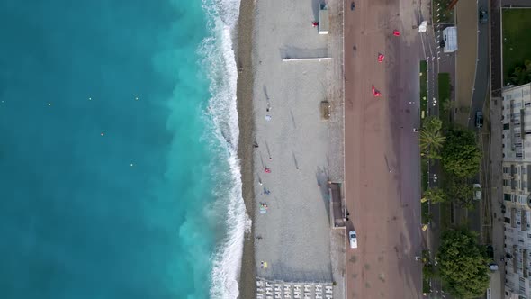 Top-down aerial shot of a beach in Nice city in Cote d'Azur region, France