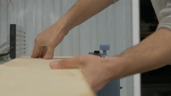 Passing a wood board through a joinery machine