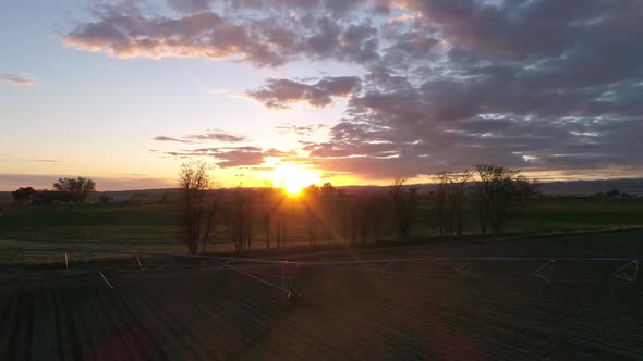 Panning view of sunset over farm field