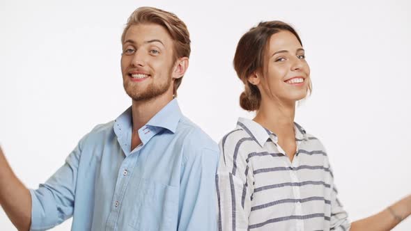 Successful Caucasian Couple Standing Back to Back on White Background