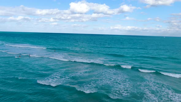 People Swim At Blue Waters Of Miami Beach In Florida, United States With Hotels And Skyscrapers. aer