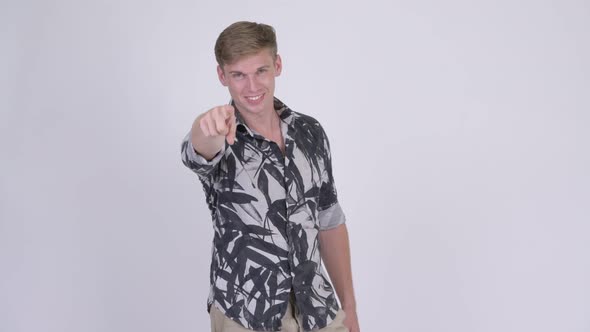 Happy Young Handsome Tourist Man Pointing at Camera