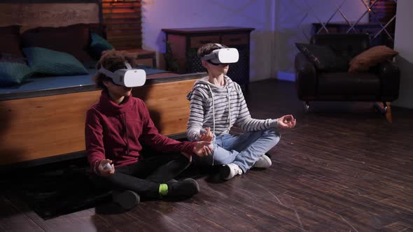 Boys in VR Glasses Meditating in Lotus Pose