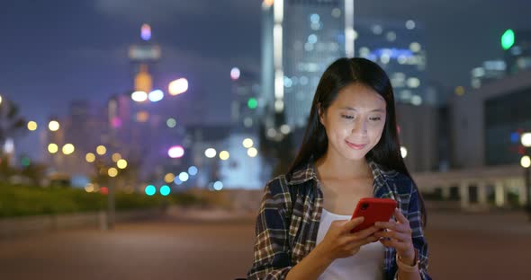 Woman Look at Cellphone in City at Night