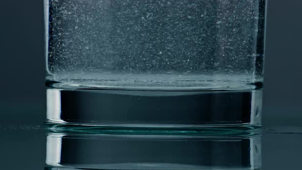 Closeup Fizzy Water Bubbling in Glass