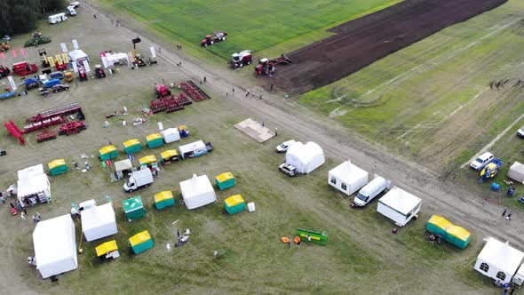 Aerial View of Green Field Where Harvest is Being Harvested