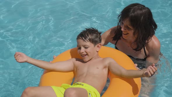 Caucasian Mom and Boy Playing in a Swimming pool, Happy moments, Slow motion