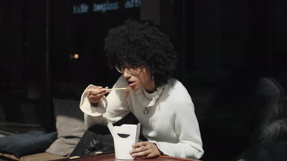 Mixed Race Woman Eating Street Food