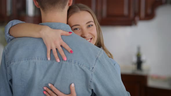 Portrait of Beautiful Young Woman Hugging Man Looking at Camera Smiling