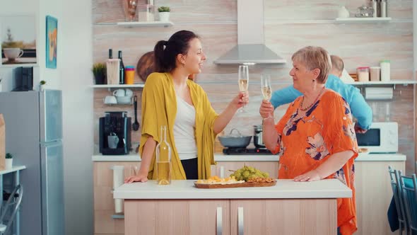 Mother and Daughter Clinking Glasses of Wine