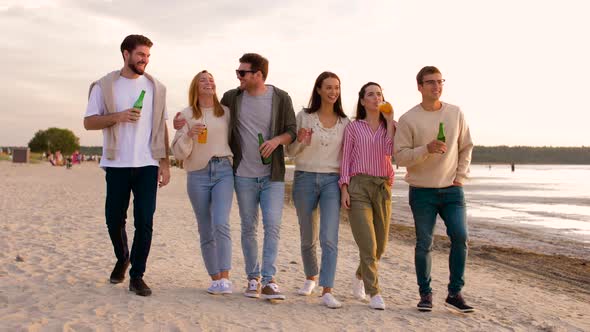 Friends with Non Alcoholic Drinks Walking on Beach