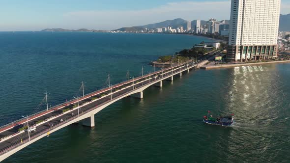 Shooting Aerial Unmanned Flight From Top View of the City Bridge with Cars and Motorbikes Against