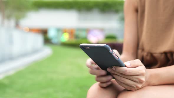 Woman using mobile phone in the park