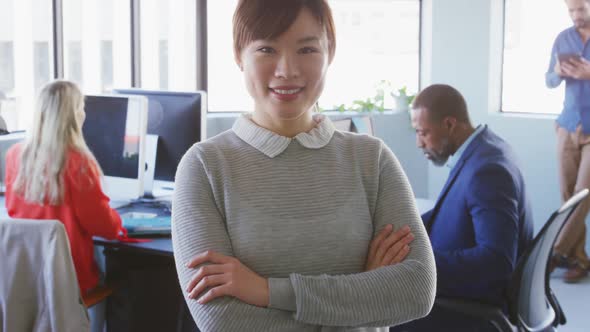 Businesswoman looking at camera in modern office