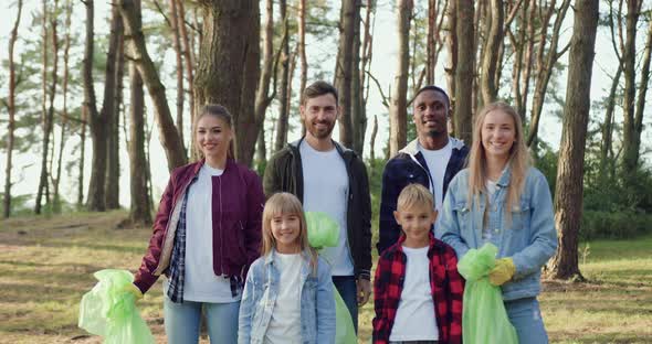 Volunteers Which Standing in front of Camera with Rubbish Bags Full of Waste After Cleaning Park