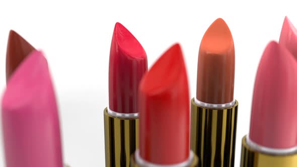 Samples of the Red Tint Lipsticks in the Golden Case on the White Background